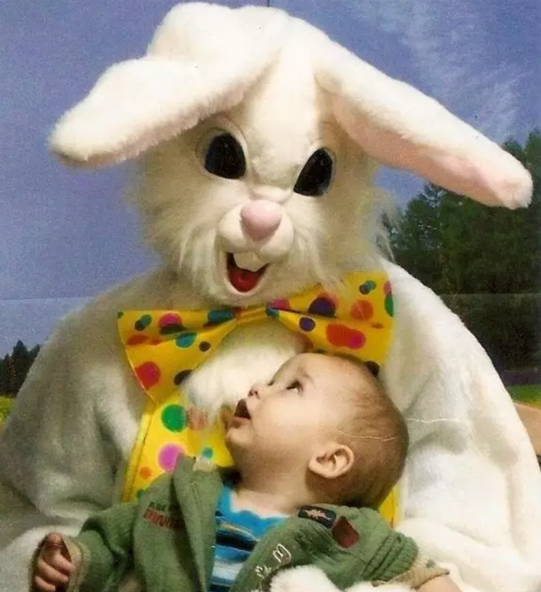 a creepy easter bunny looking down at a boy as prey