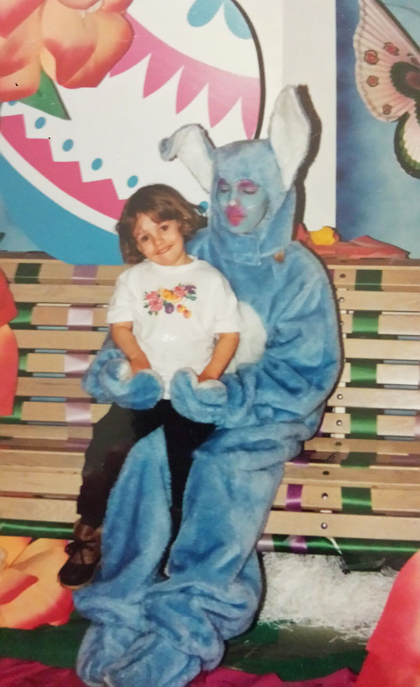 blue creepy bunny holding a girl in his arms