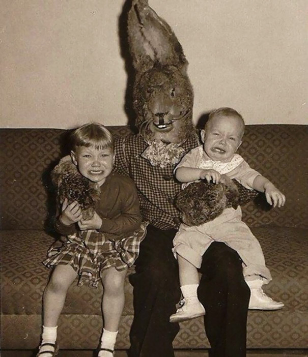 Bunny holds children in both arms