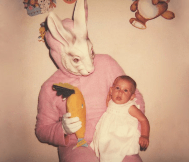creepy easter bunny offering gift to baby