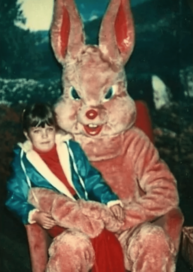 red Easter bunny with child trying to get away