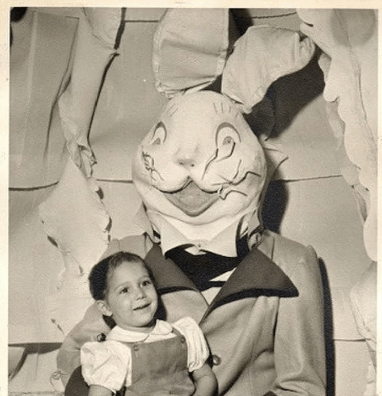Vintage easter bunny holds boy in clutches
